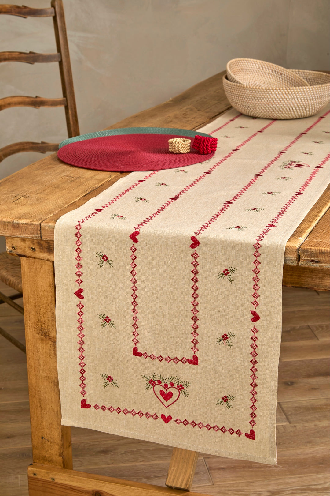 Embroidered Heart and Holly Runner on a rustic table for festive styling with decorative bowls.