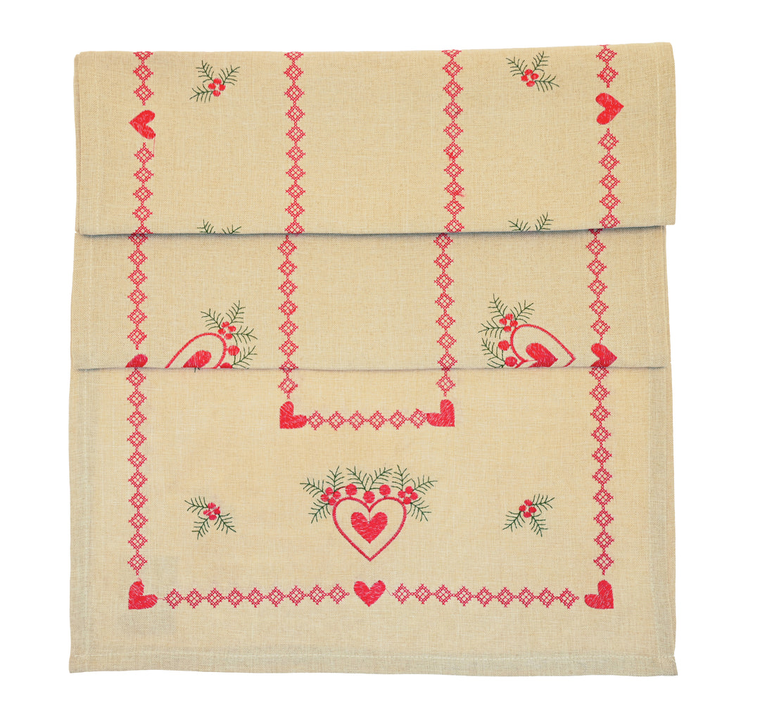 Embroidered Heart and Holly Runner featuring red hearts and holly on a natural linen background for festive styling.