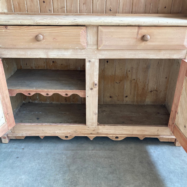 quirky carved detail on shelf on left hand cupboard on pine dresser
