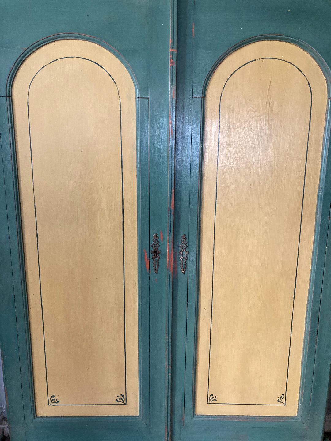 green and yellow Danish wardrobe with arched features on double doors