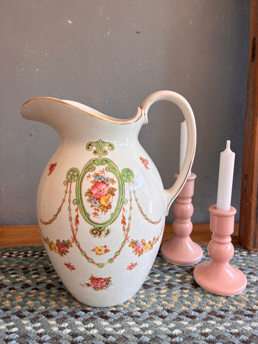Pretty Floral Victorian Water Jug - Fielding's Devonware displayed next to pink candle holders.