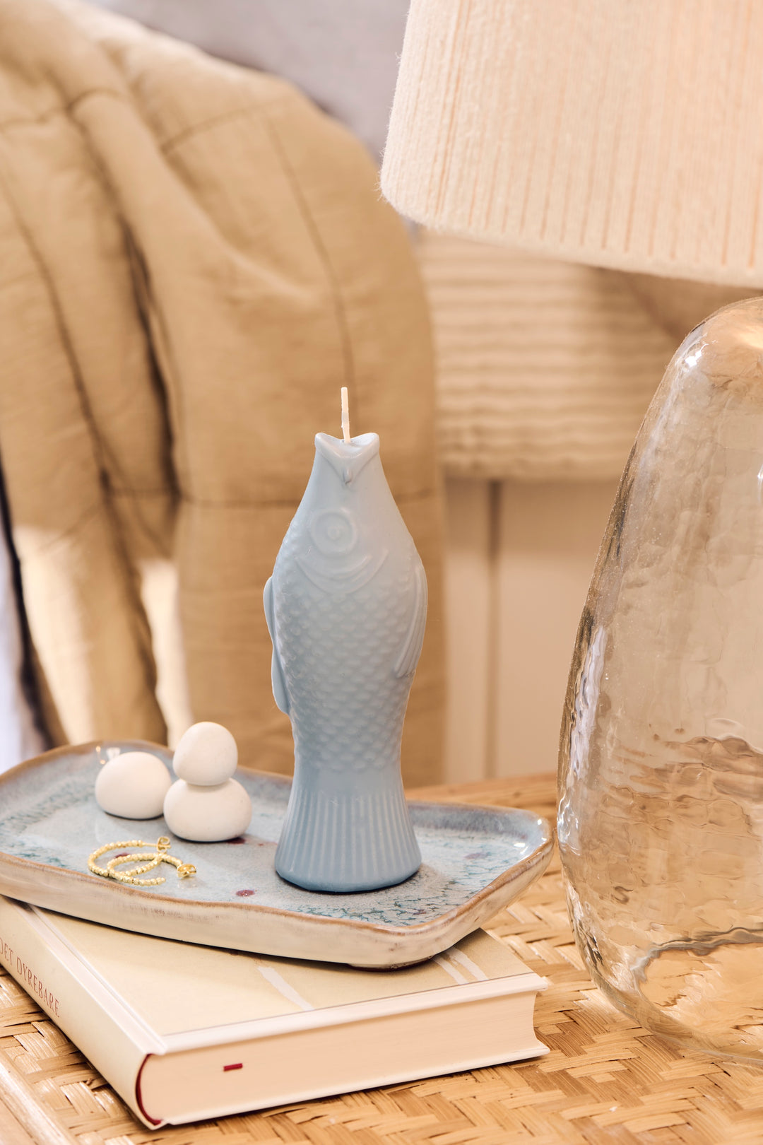 Quirky fish-shaped dusty blue candle on a decorative tray, enhancing home decor with playful charm. Source for the Goose, Devon.