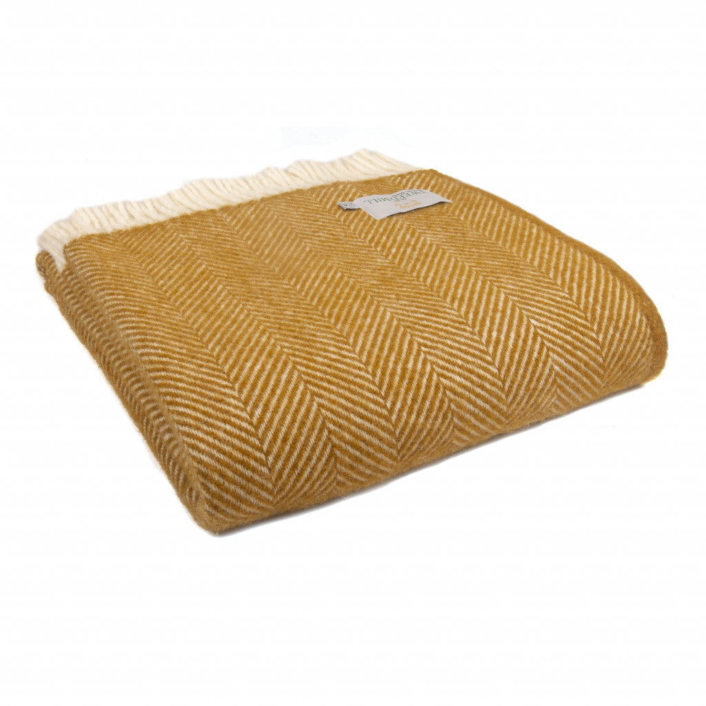 Tweedmill Fishbone English Mustard Blanket with cream tassels from Source for the Goose Devon, adding warmth and rustic charm to any room.