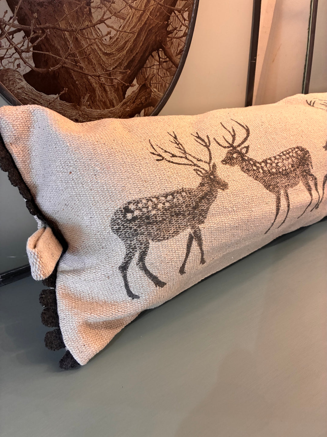 Forest Stag Draught Excluder Cushion featuring rustic stag silhouettes on a natural cotton background.