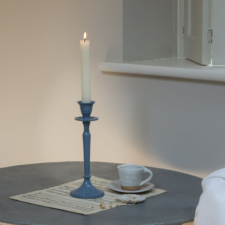 pretty blue enamel candlestick with a simple white dinner candle