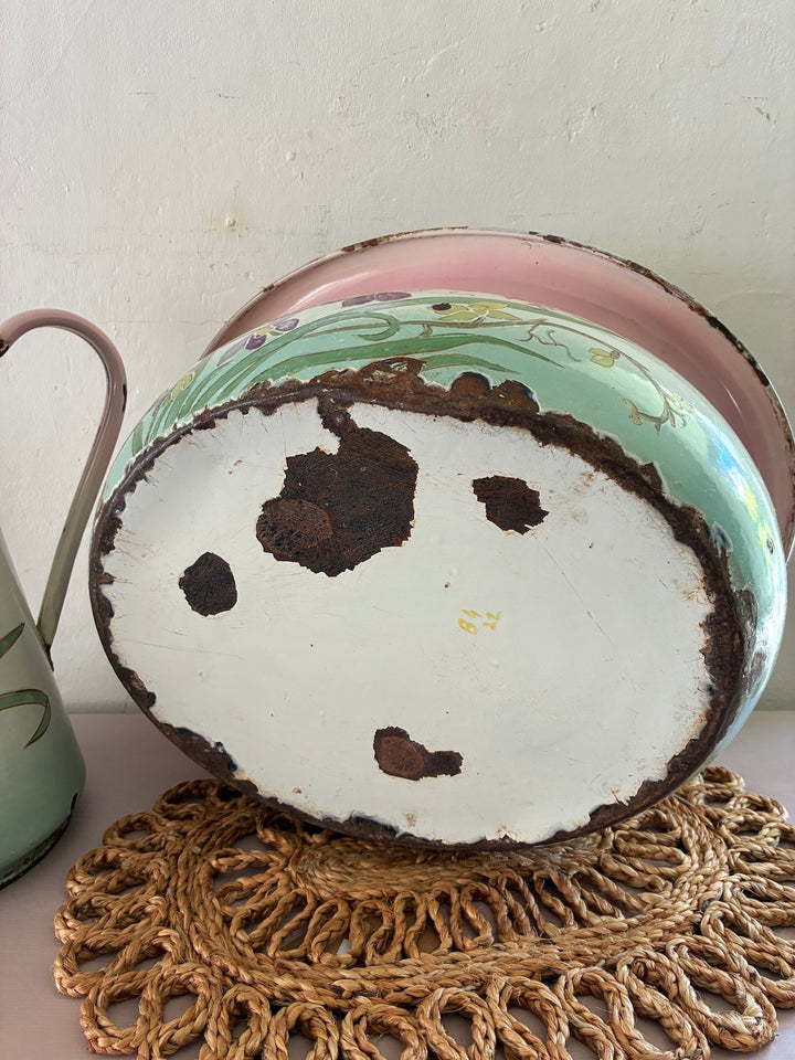 Bottom view of a vintage Art Nouveau French enamel bowl showcasing pastel floral design and classic elegance.