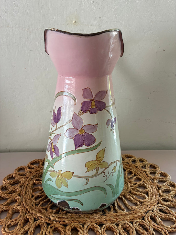 Art Nouveau French enamel jug with pastel floral design and pink top, adding vintage elegance to home decor.
