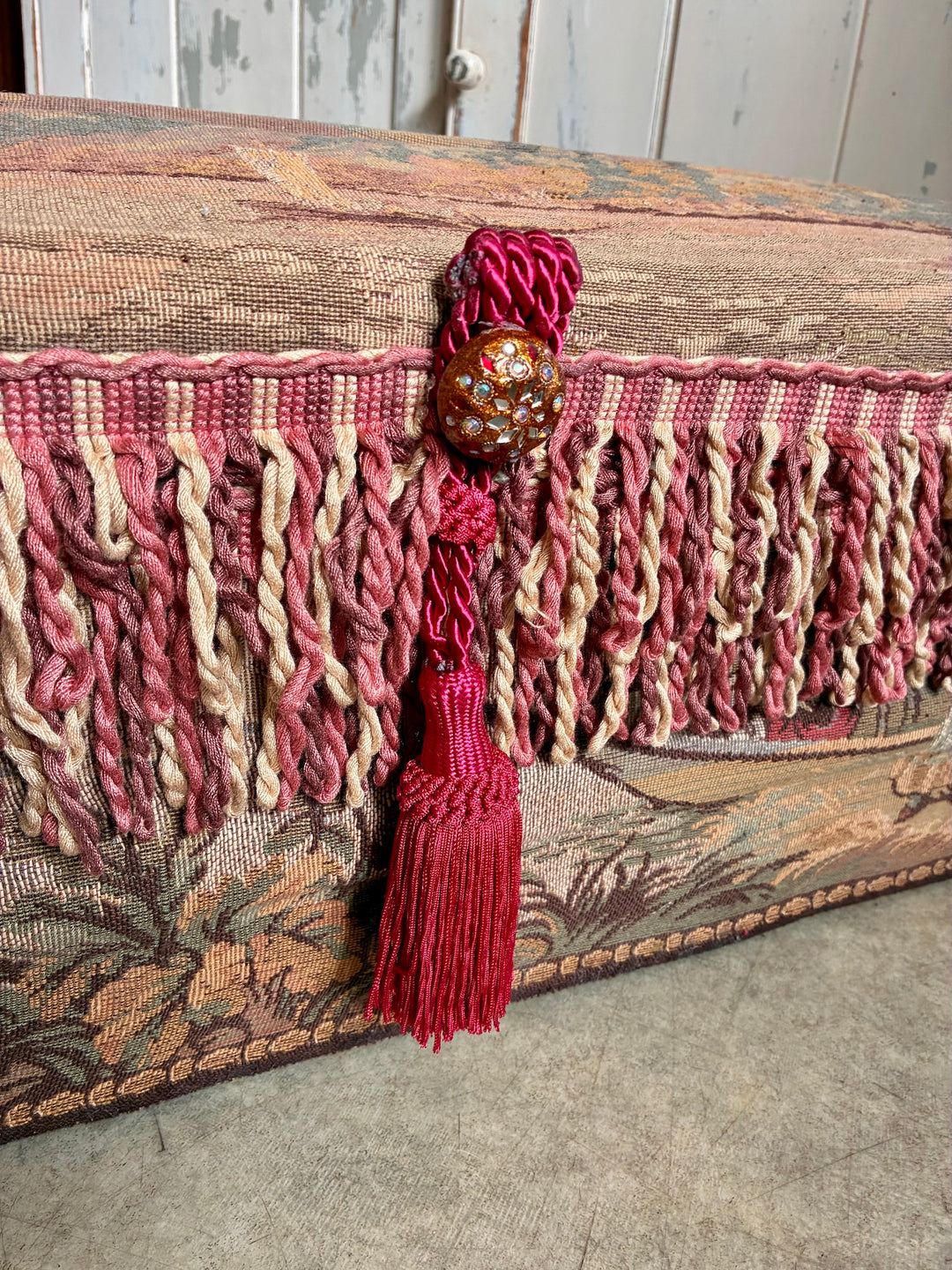 French Upholstered Storage Trunk - Bridal Trunk with pink tassels and rich tapestry fabric detail.