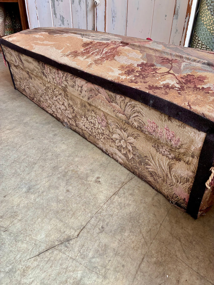 French Upholstered Storage Trunk - Bridal Trunk with vintage tapestry fabric and pink tassels, shown side view.