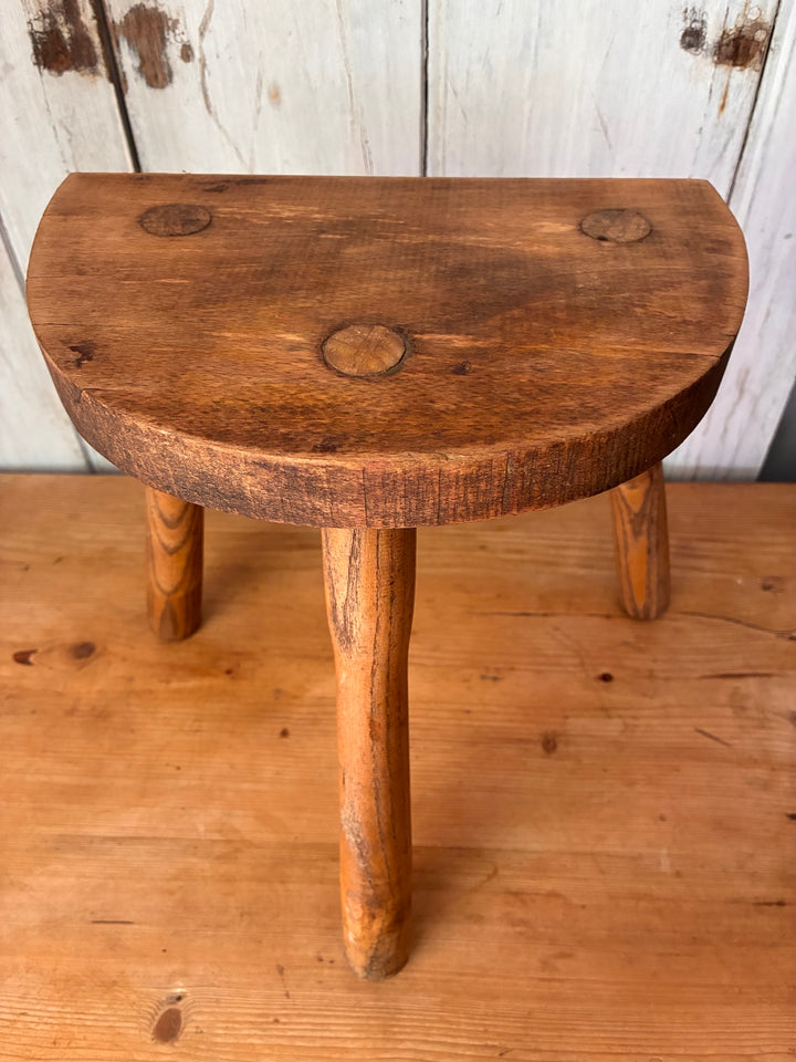 Vintage Wooden French Tripod Stool with rustic demi-lune seat and sturdy legs, perfect accent for home decor.