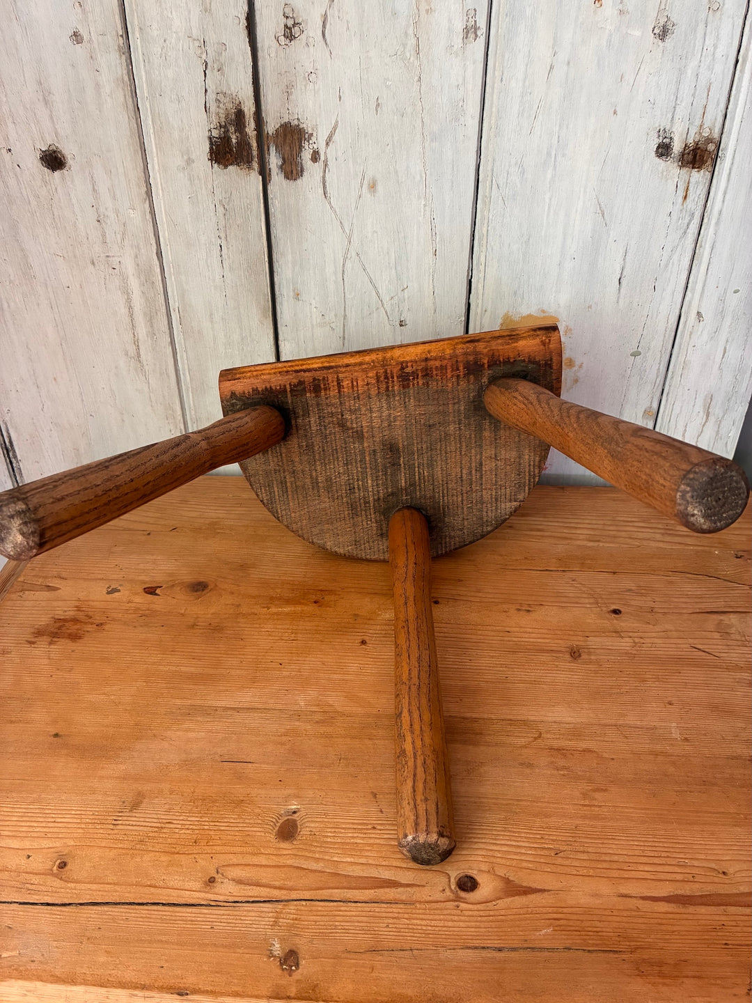 Vintage Wooden French Tripod Stool top view showing three sturdy legs and demi-lune shaped seat, rustic style accent.