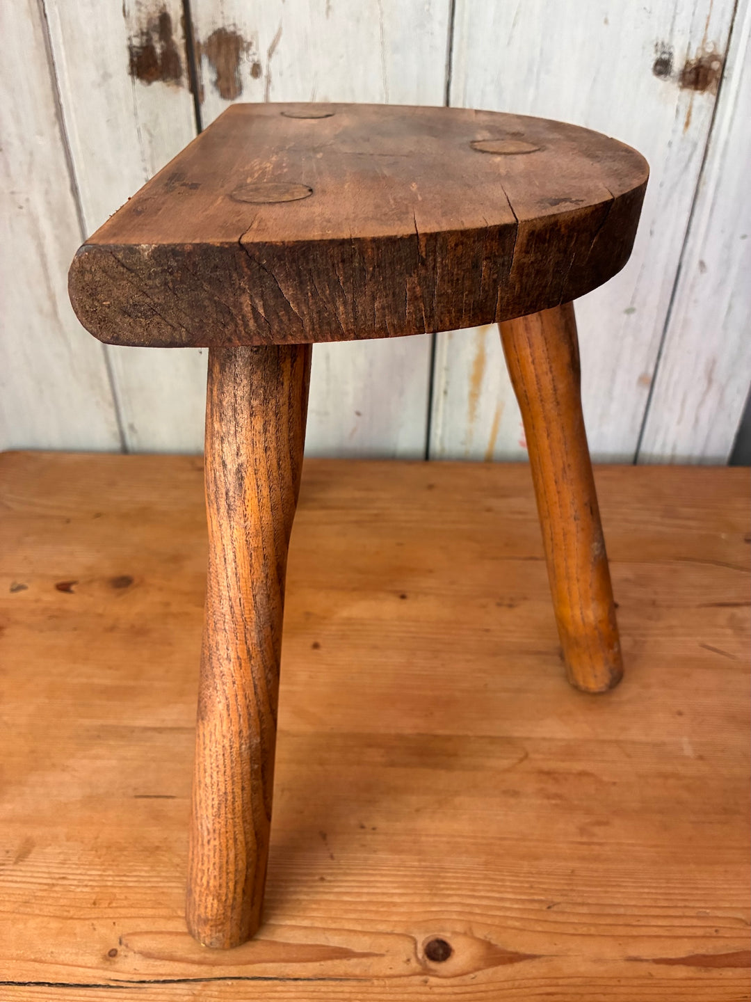 Vintage Wooden French Tripod Stool showcasing rustic charm with hand-carved details and sturdy legs.
