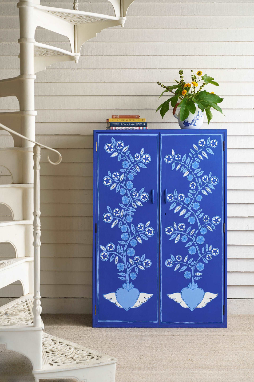 painted cupboard with flower design in Annie Sloan Frida Blue