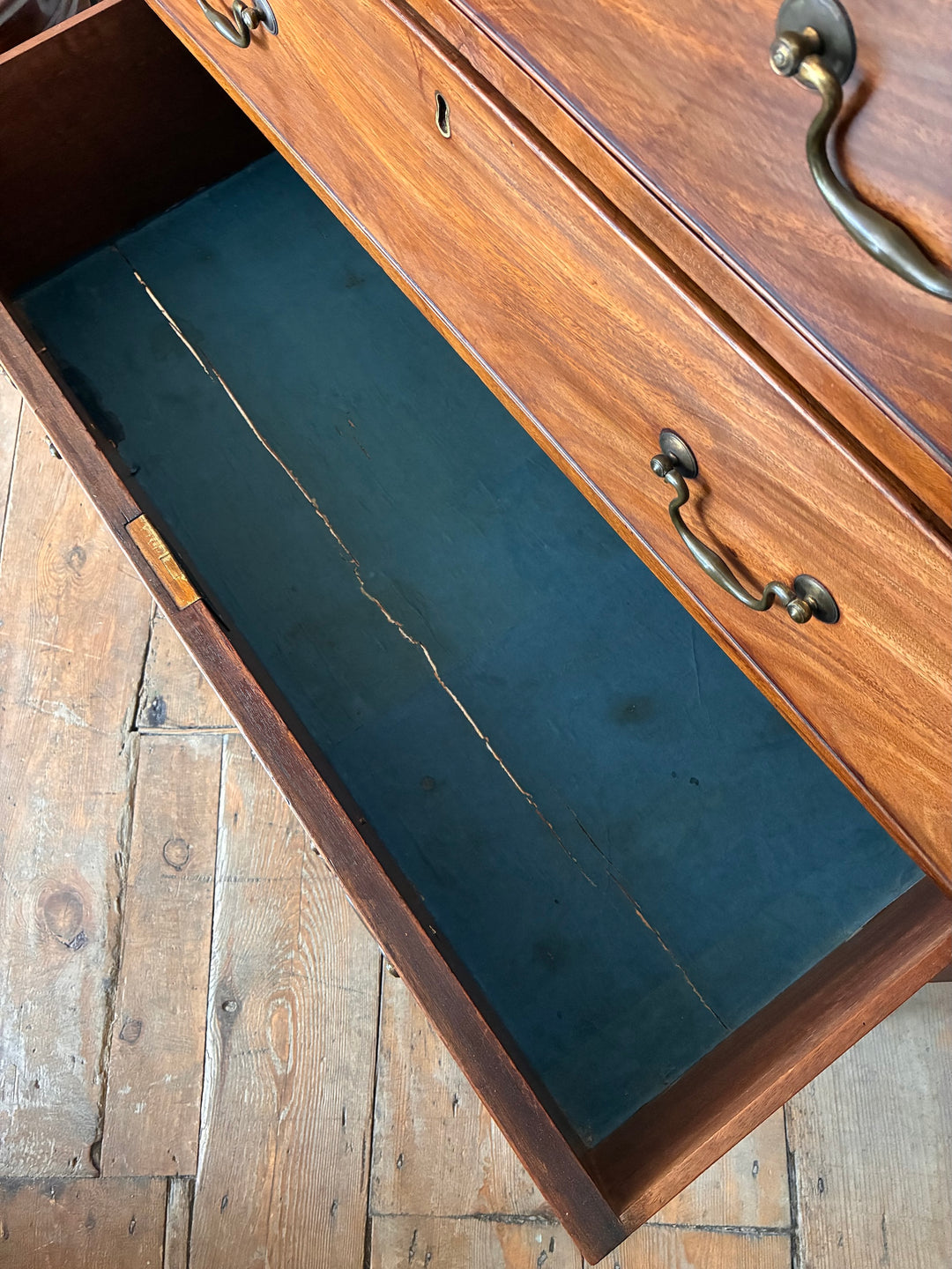 Inside view of the Antique Georgian Mahogany Chest of Drawers showing original blue paper lining.