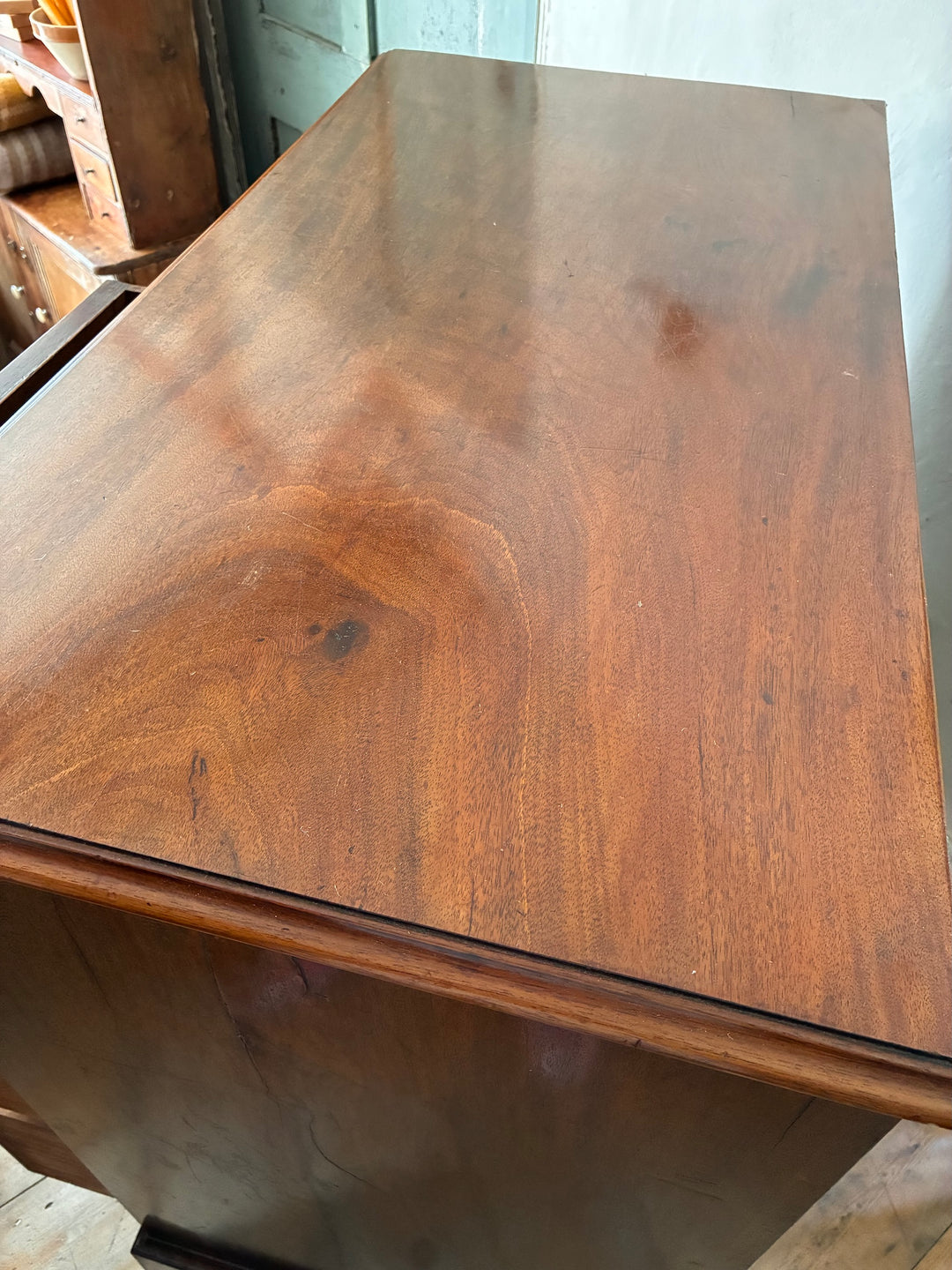 Top view of an Antique Georgian Mahogany Chest of Drawers showcasing rich wood grain and elegant finish, sourced from Devon.