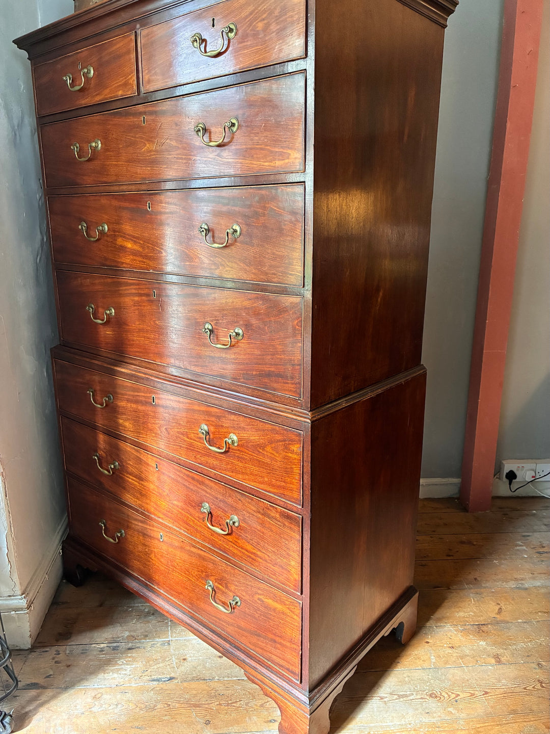 Georgian Mahogany Tall Boy - Chest on Chest showcasing antique mahogany craftsmanship with brass handles and eight drawers.