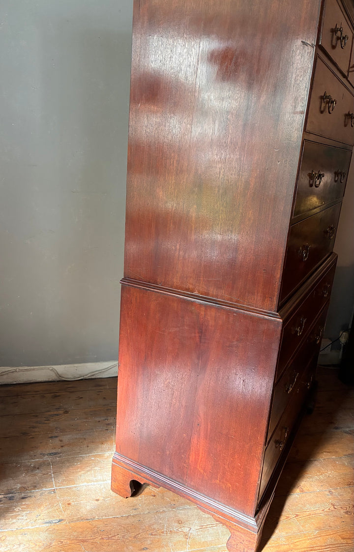 Georgian Mahogany Tall Boy - Chest on Chest showcasing rich wood grain and brass handles in a classic antique style.