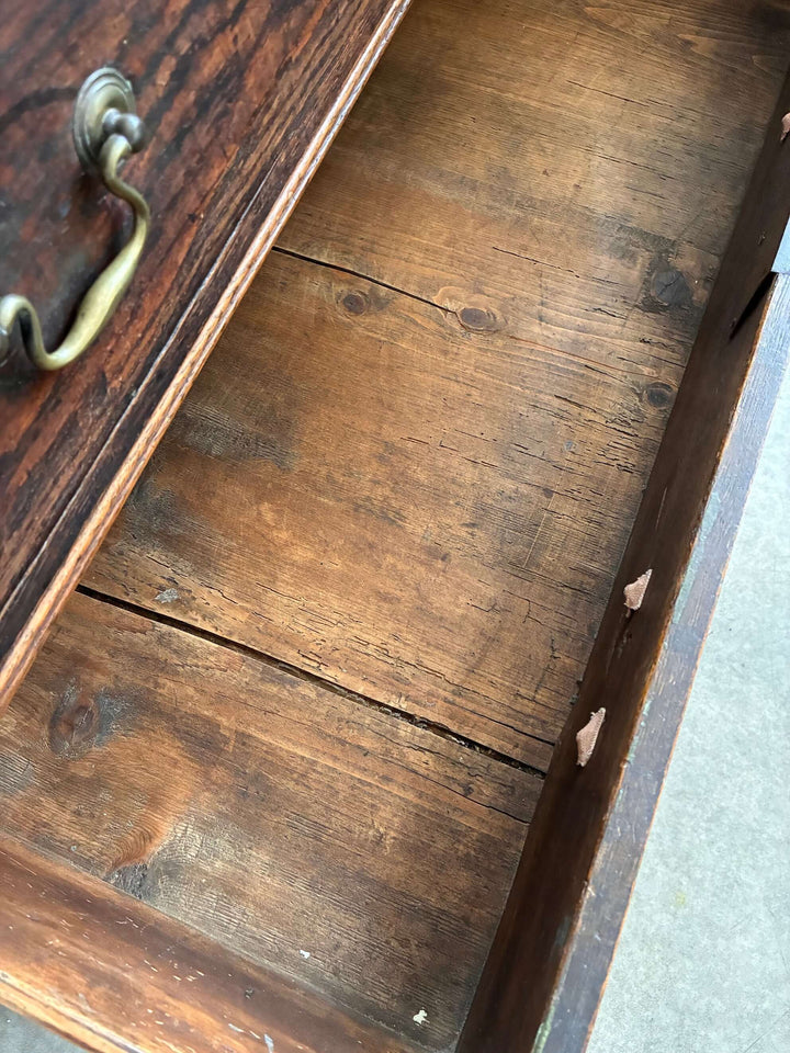 Interior view of Antique Oak Georgian Chest of Drawers, showcasing spacious wooden drawer with traditional handle.