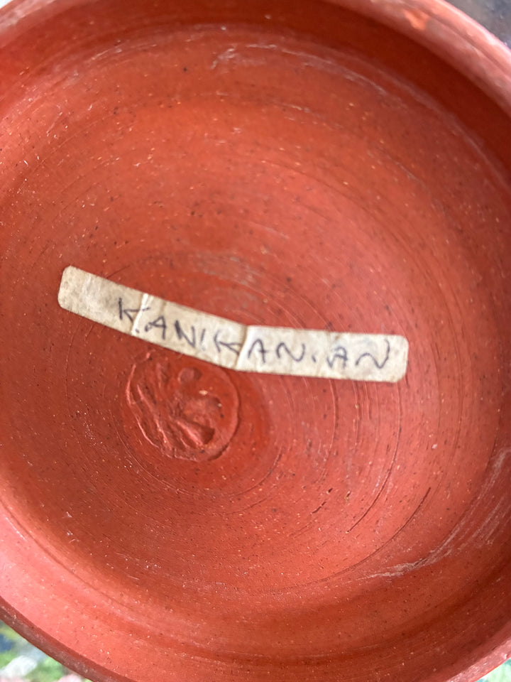 Base of studio pottery vase showing the artist's signature Kanikanian on a label.