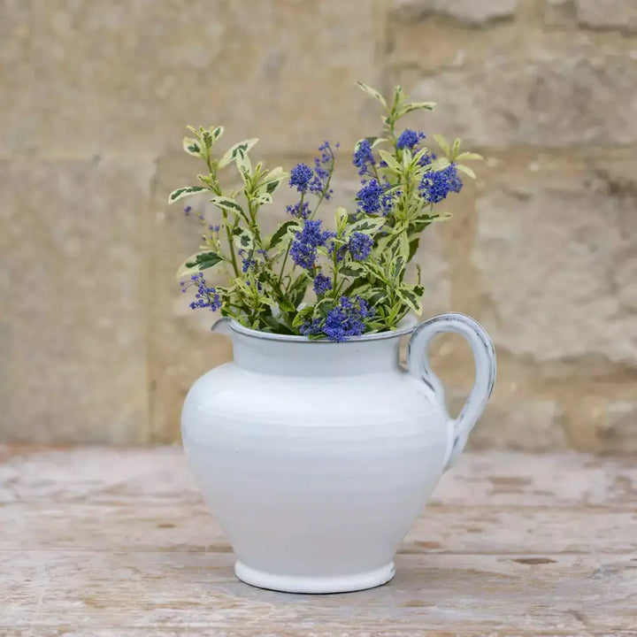 Short glazed white ceramic jug with wildflowers, perfect for vintage style and rustic home decor