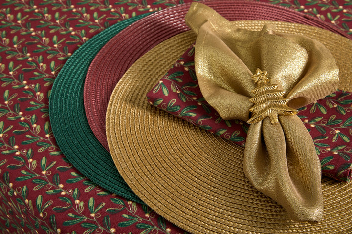 Circular Gold Placemat with green and burgundy accents on a festive table setting.