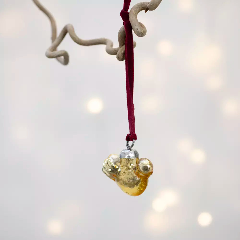 Gold Glass Bird Decoration With Velvet Loop hanging with a rich red velvet loop on a Christmas tree.