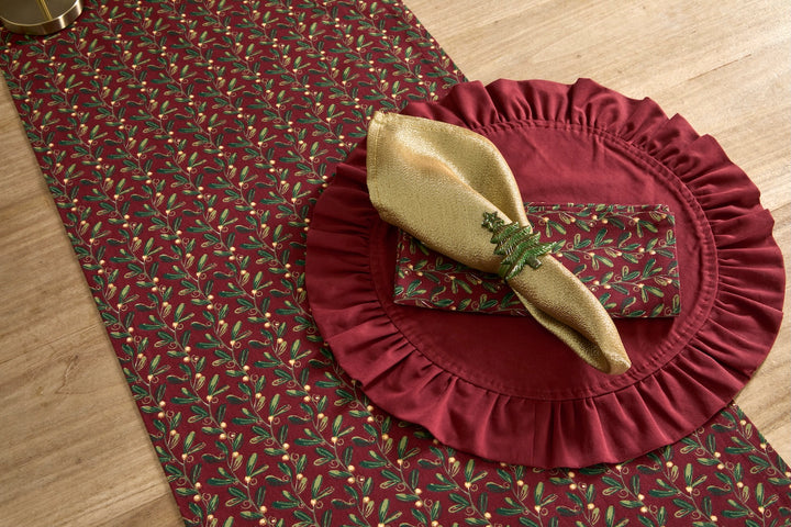 Under The Mistletoe Table Runner with mistletoe design and gold napkin ring for festive styling.