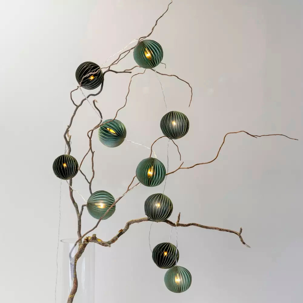 Green Pleated Paper LED Garland displayed on a branch with warm lights and eco-friendly design from Source for the Goose Devon.