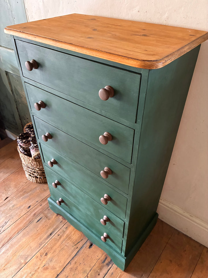 Tall Dark Green Chest of Drawers showcasing hand painted rustic country design with natural wooden top and dark knobs.