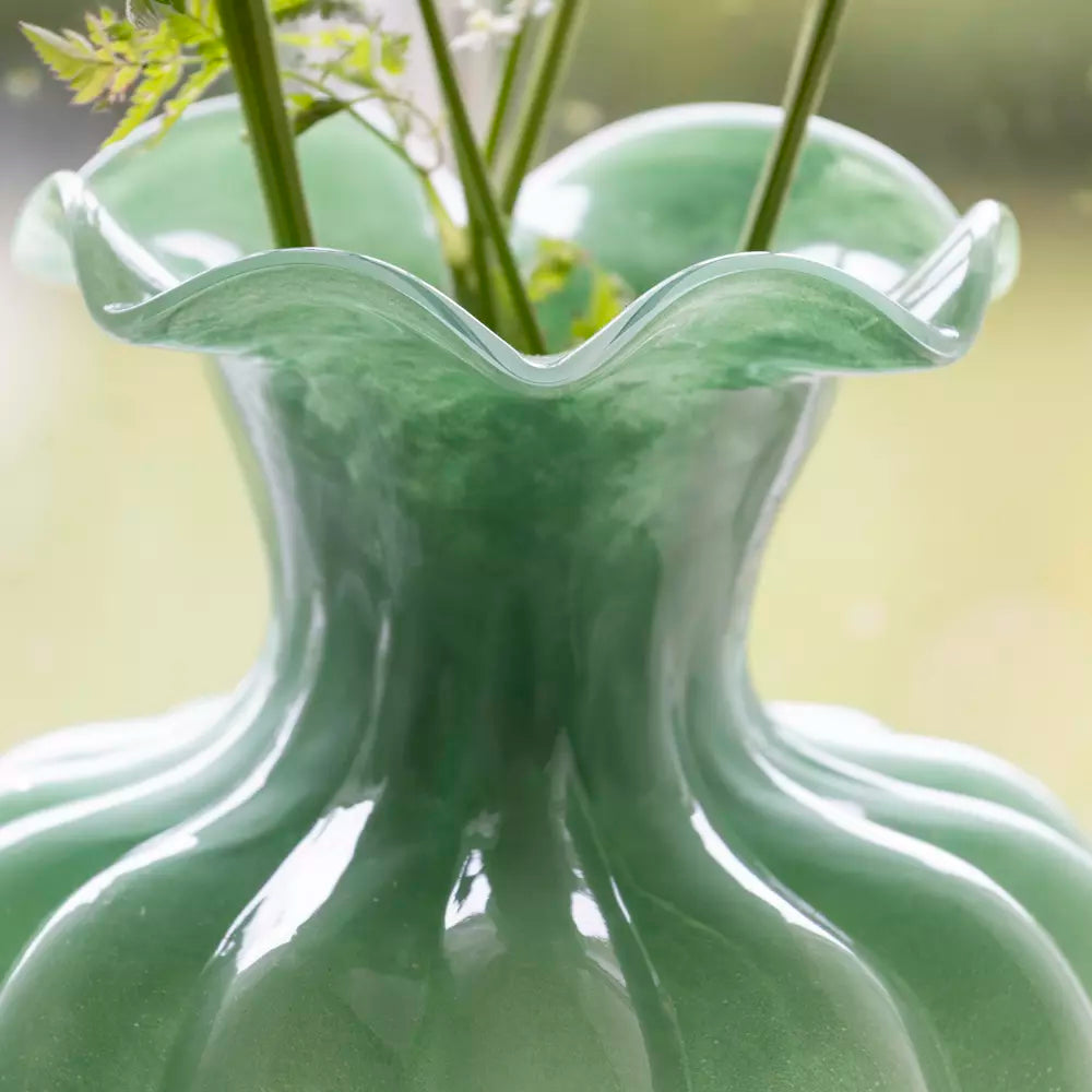 Green Glass Vase with Frill Rim - Bethany showcasing delicate blooms in a stylish home setting.