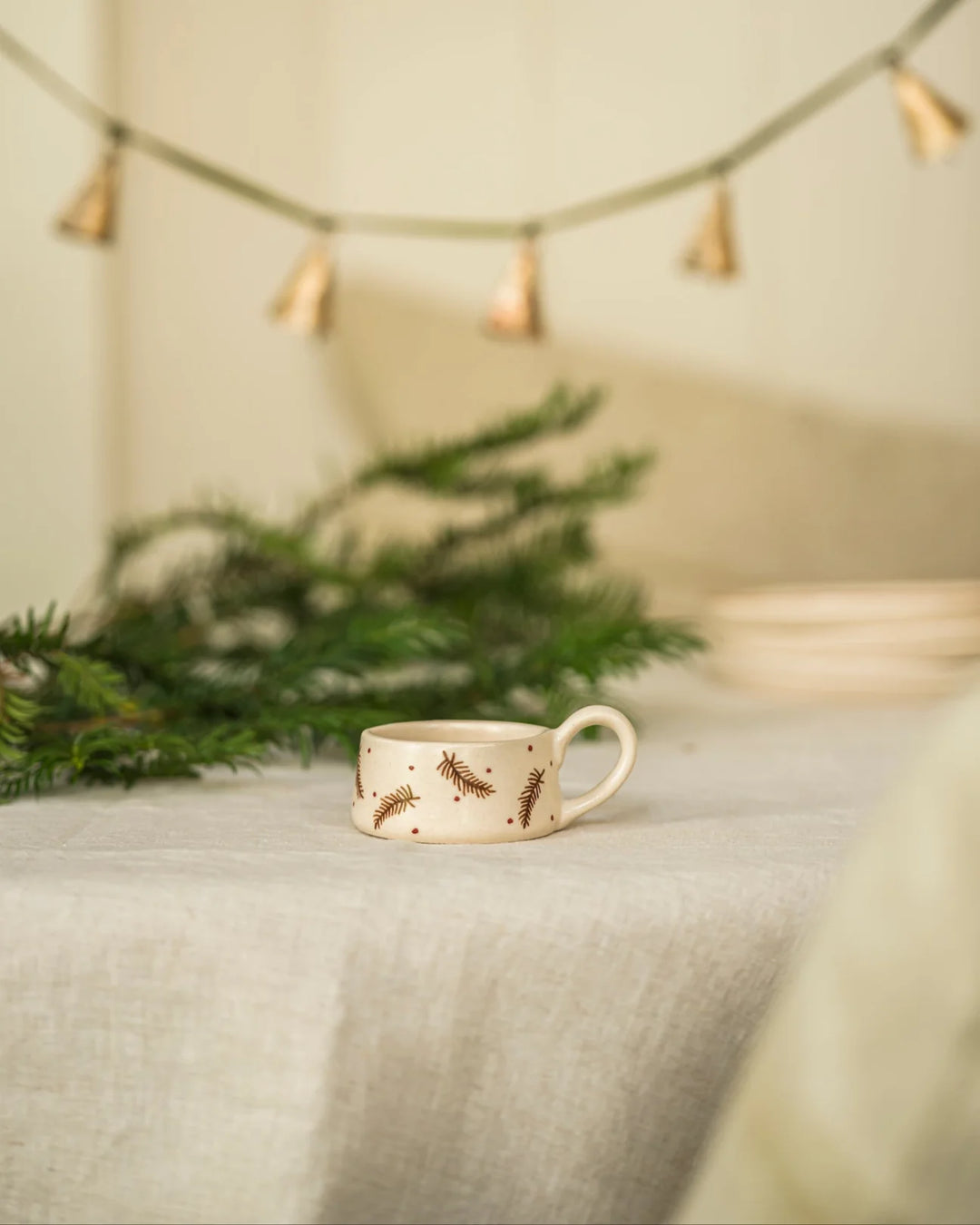 Hand Painted Pine Tea Light Holder - Pine on a table with greenery and festive decor, showcasing vintage style and cottage core charm.