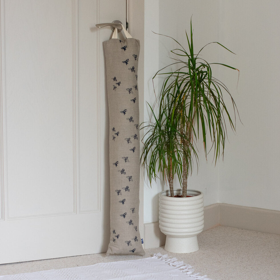 linen draught excluder by Helen Round with hanging loop and bee design