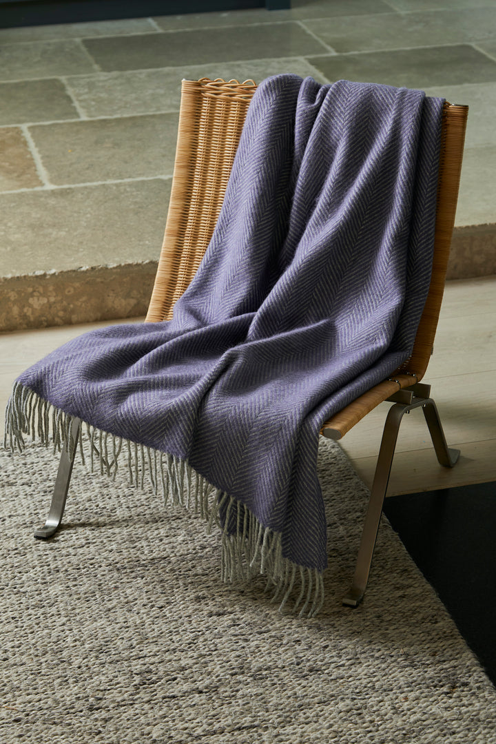 lavender pure wool throw with silver grey tassels draped over a chair