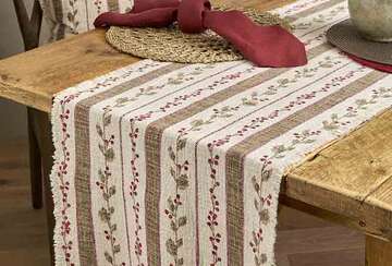 Slub Cotton Holly Berry Christmas Table Runner - Two Colourways on a rustic wooden table, adding festive charm.
