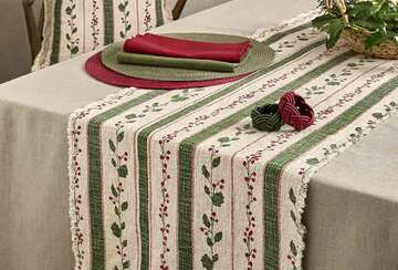 Slub Cotton Holly Berry Christmas Table Runner - Two Colourways displayed on a festive dining table with green and red accents.