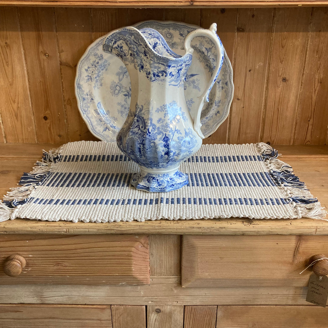 blue and off white placemat mad from recycled cotton with vintage blue and white jug placed on top