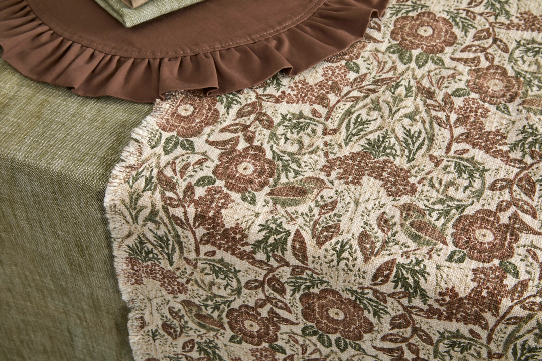 Jenny Wren Table Runner - Hand Block Print on a green table, showcasing intricate floral design and rustic charm for table styling.