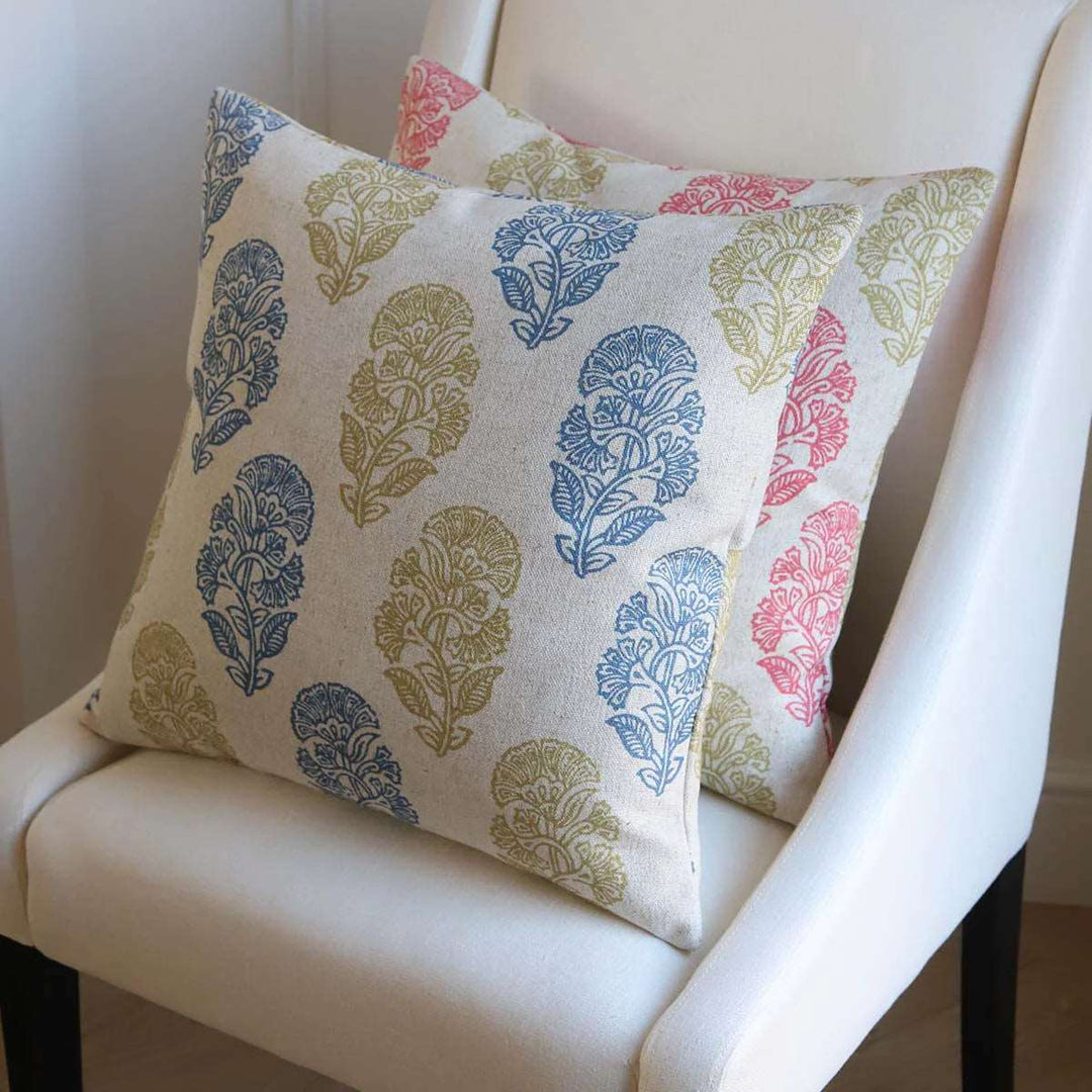 two Jodpur cushions with lime and blue design at the front placed on a chair