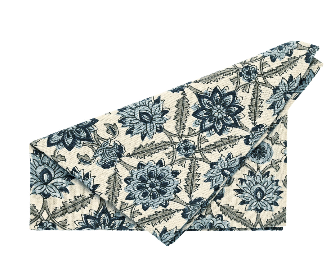 Blue and White Kelmscott Napkin - Set of Four folded, featuring floral pattern, ideal for elegant table settings.