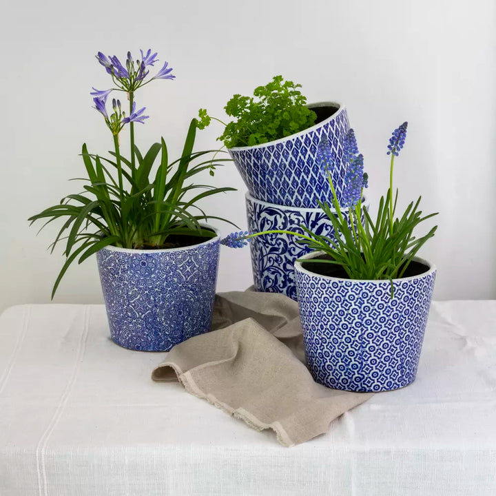 Large Blue Dutch Style Vintage Design Flowerpot with vibrant plants on a neutral tablecloth.
