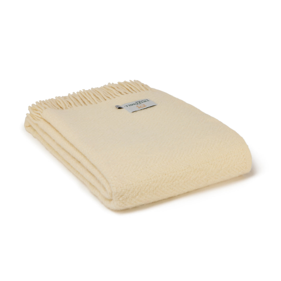 The Moorland - Cream Wool Throw, a soft clotted cream blanket with herringbone weave, perfect for a cosy home in Devon.