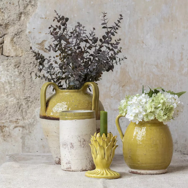 Mustard Yellow Rustic Glazed Vase displayed with other decorative items in a charming rustic setting.