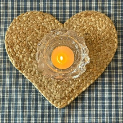 heart shaped coaster in sustainable jute with a glass tealight on top