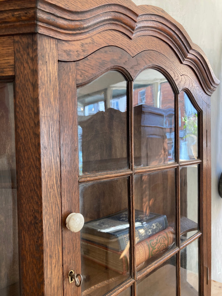 Antique oak wall cabinet with glass door and porcelain knob, showcasing vintage Dutch design by Source for the Goose, Devon.
