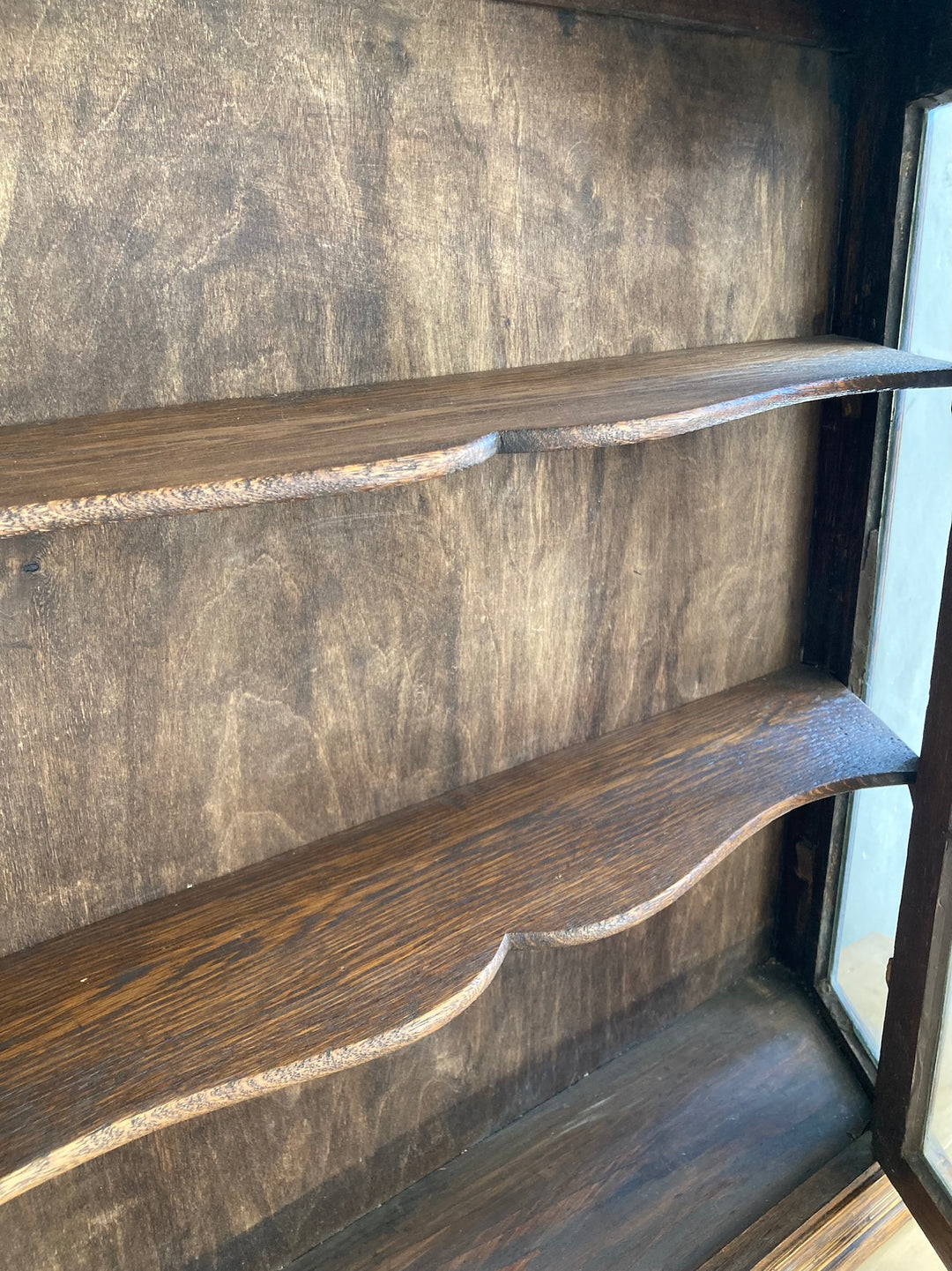 Interior shelves of Antique Oak Wall Cabinet with Glass Door, showcasing classic craftsmanship and vintage design.