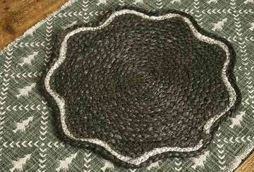 Dark Green Scalloped Jute Placemat on a textured surface, featuring white trim, ideal for festive dining.