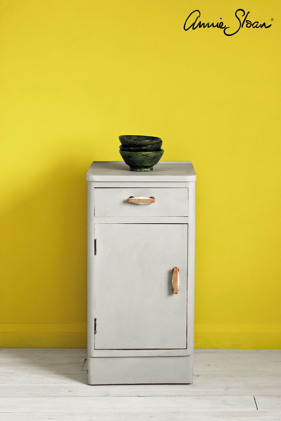 Annie Sloan Paris Grey bedside table against a wall painted in English Yellow