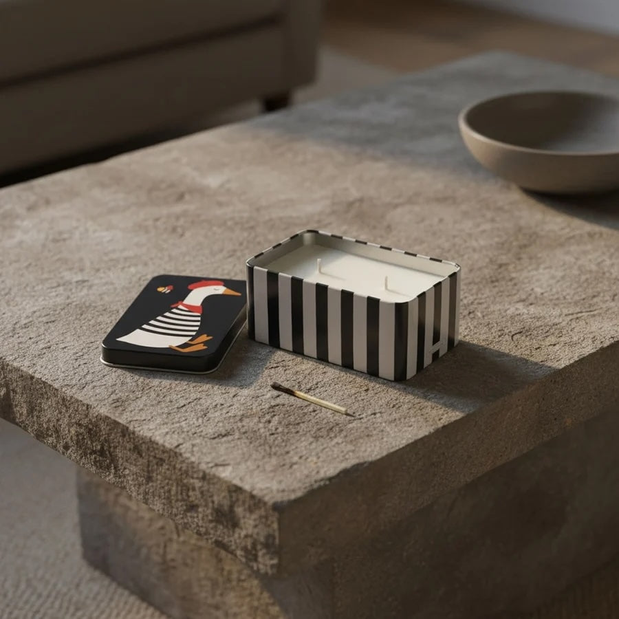 Lemoncello Scented Candle in a Tin - Parisian Duck on a stone table with a matchstick.