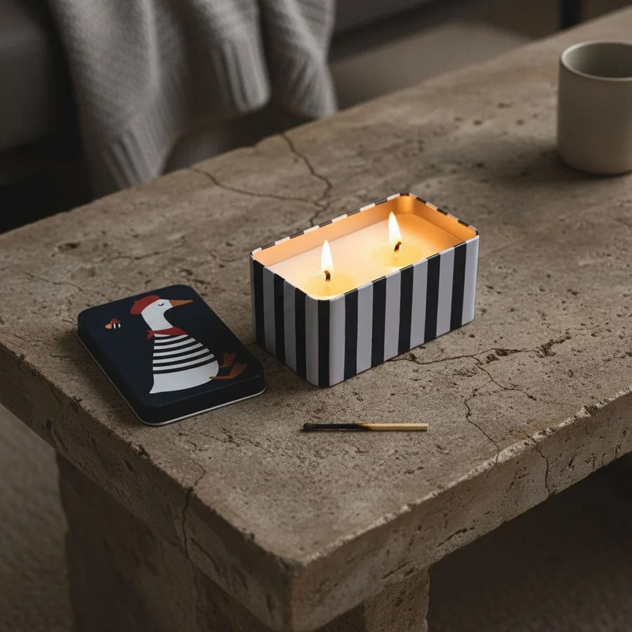 Lemoncello Scented Candle in a Tin - Parisian Duck displayed on a rustic table with a match and tin lid.