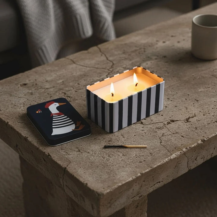 Lemoncello Scented Candle in a Tin - Parisian Duck displayed on a rustic table with a match and tin lid.